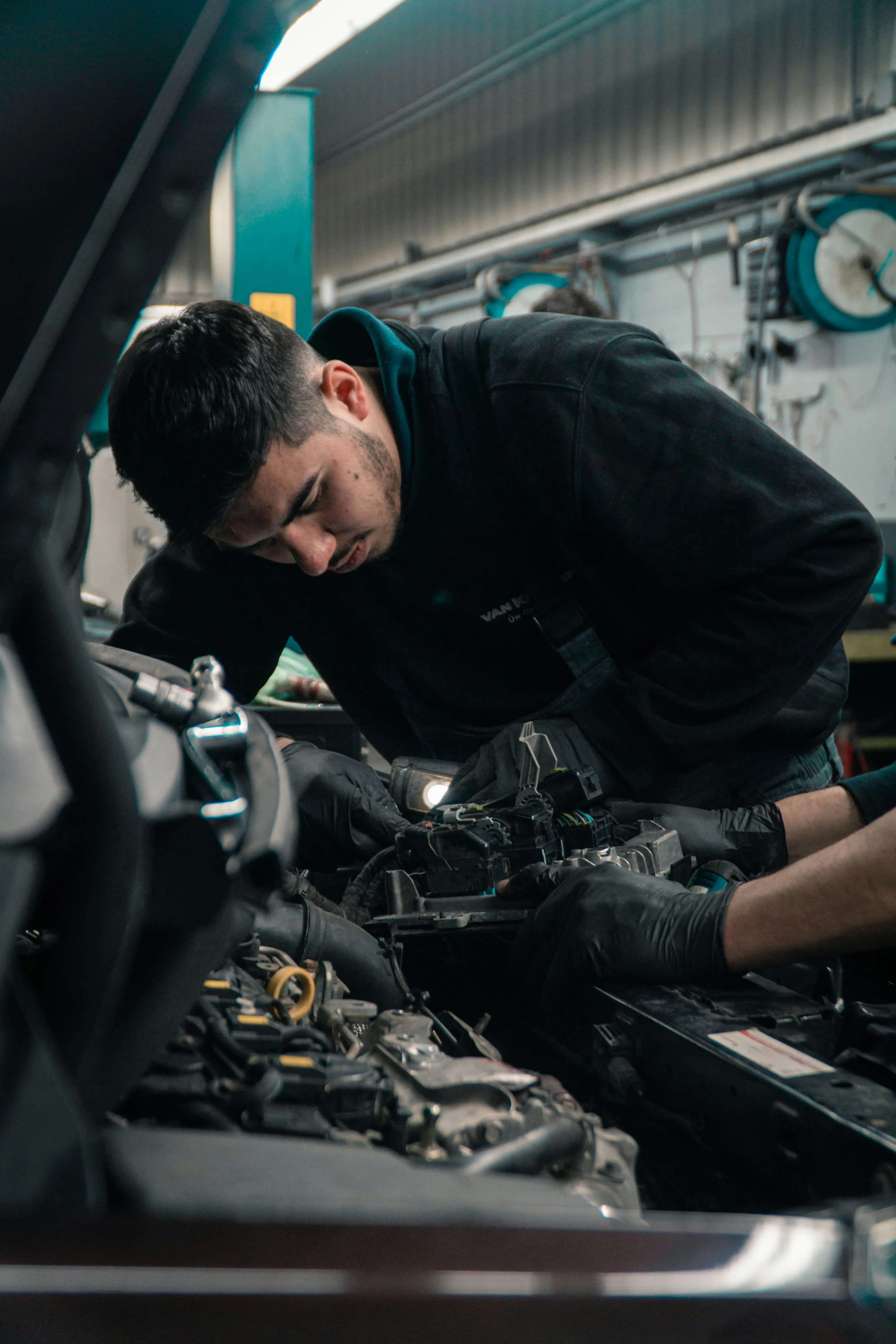A mechanic working on a car engine