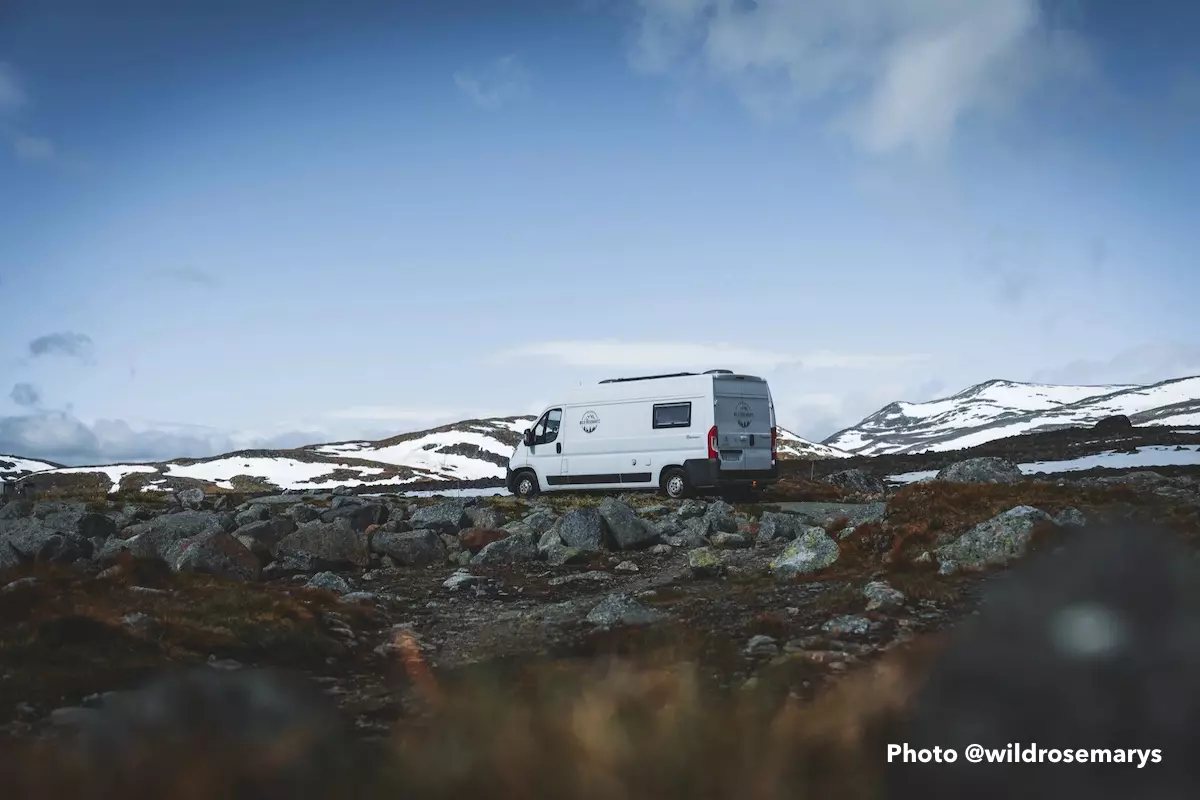 A lone van in the middle of a winter desert landscape