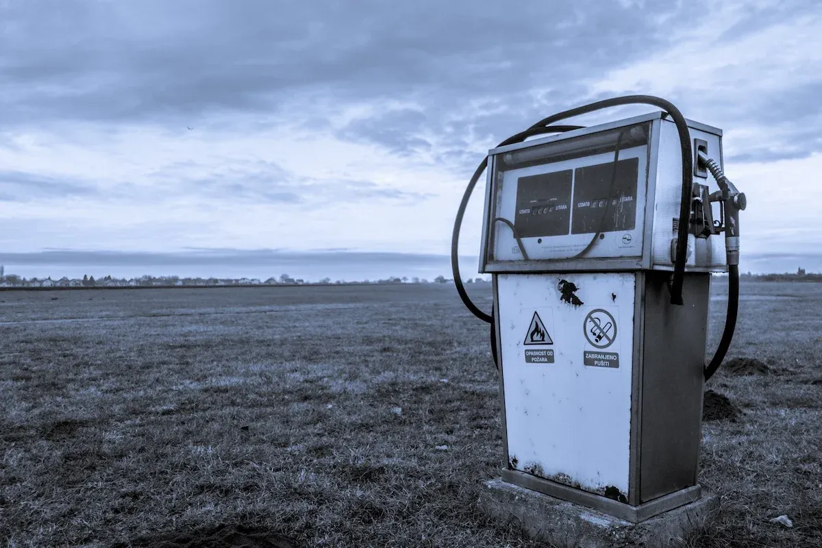 A lone petrol pump in the middle of a desert landscape