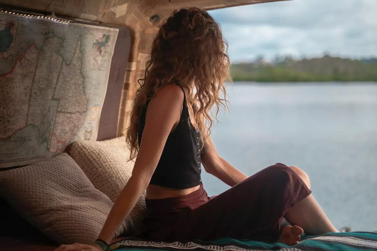 A traveler sitting in her converted van